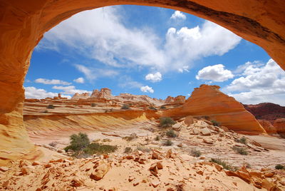 Panoramic view of desert against cloudy sky