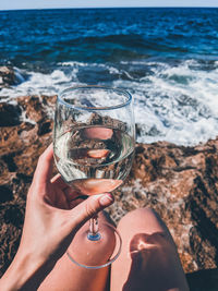 Reflection of person holding glass of water