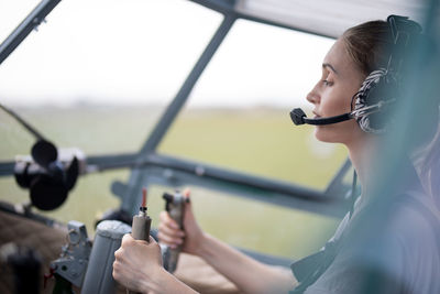 Female pilot sitting at the wheel of the plane
