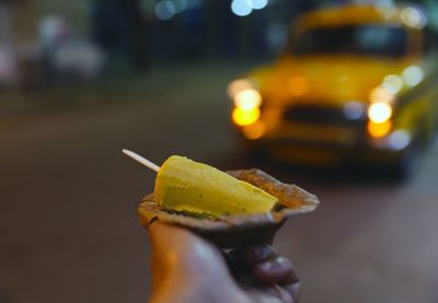 Close-up of hand holding leaf