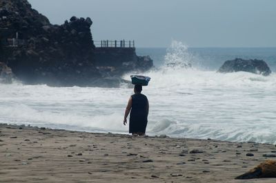 Man looking at sea against sky