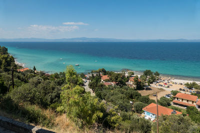 High angle view of buildings by sea against sky