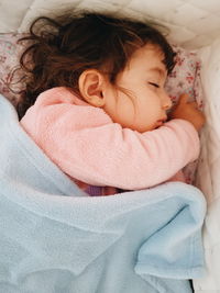 Close-up of girl sleeping on bed