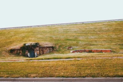 Old house on grassy field