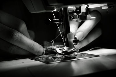 Close-up of person working in machine