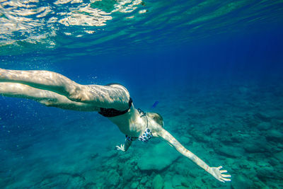 Young woman swimming in sea