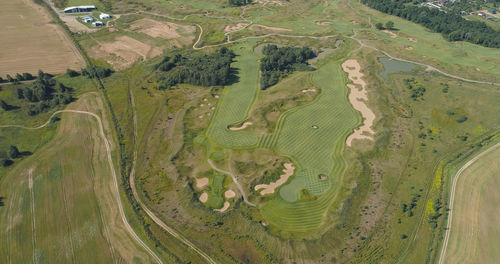 Aerial view golf course with green grass and ponds. golf field in the countryside.