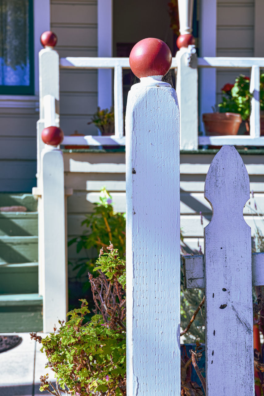 architecture, plant, blue, nature, day, entrance, building exterior, built structure, outdoor structure, flower, door, wood, house, outdoors, fence, porch, front or back yard, building, no people, home, front stoop, residential district, backyard, sunlight