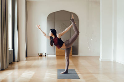 Woman with arms raised on floor