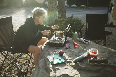 Woman cooking food at campsite