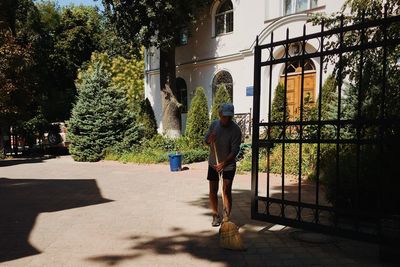 Man sweeping the yard