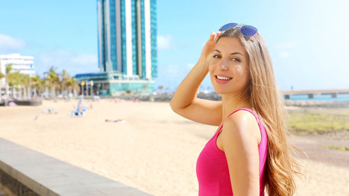 Portrait of beautiful young woman standing on land