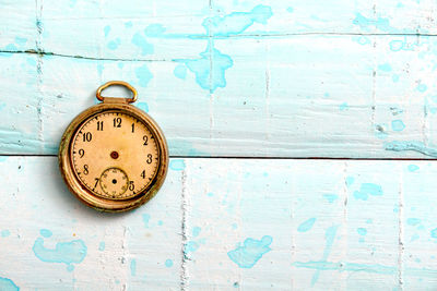 Directly above shot of old pocket watch on table