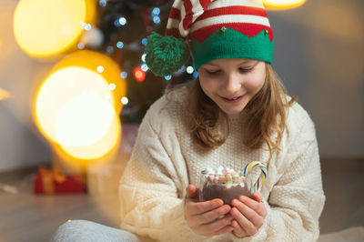 Cute girl holding hot chocolate