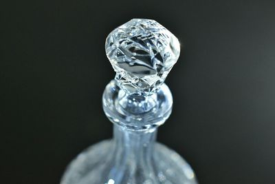 Close-up of ornate glass bottle lid