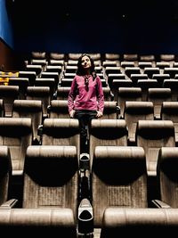 Rear view of women standing in stadium or theatre 