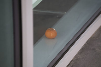 Close-up of orange fruit on window