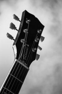 Low angle view of guitar against sky