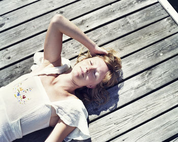 Woman lying on pier