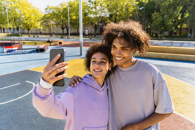 Portrait of young woman using mobile phone