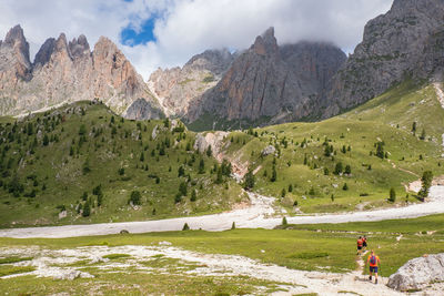 Mountainous landscape view with hikers on a trail