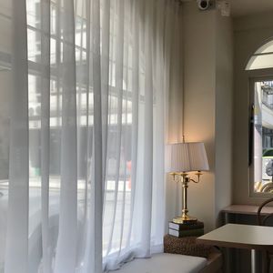 White curtains at window in house