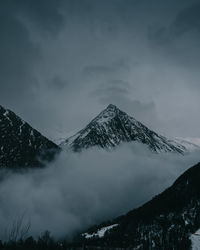 Scenic view of snow covered mountains against sky