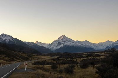 Scenic view of landscape against clear sky during sunset