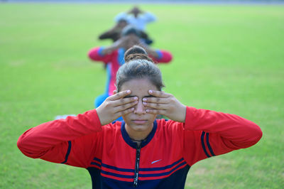 Portrait of boy wearing sunglasses standing on field