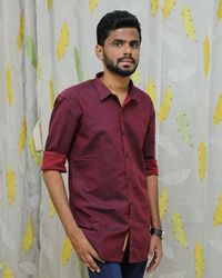 Portrait of young man standing against wall