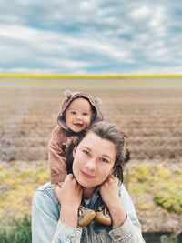 Portrait of smiling woman with baby girl