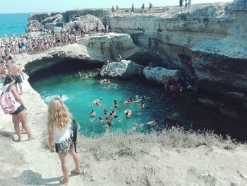 Group of people on rocks at beach