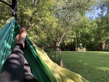 Low section of people relaxing on hammock