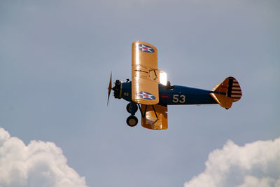 Low angle view of airplane flying against sky