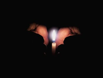 Close-up of hands over black background