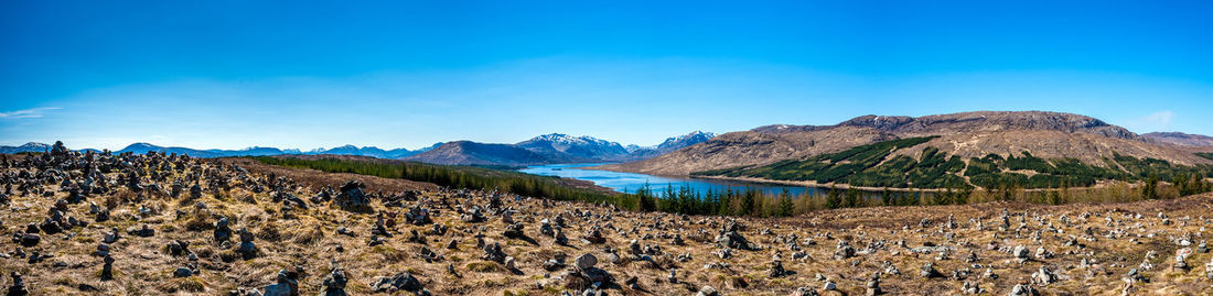 Scenic view of mountains against blue sky