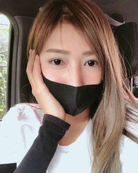 Close-up portrait of a teenage girl covering face