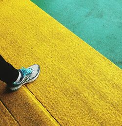 Low section of man standing on tiled floor