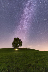 Scenic view of field against sky at night