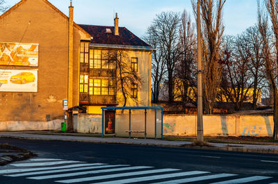 Road by building against sky in city