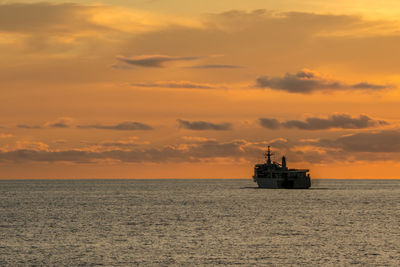 Scenic view of sea against orange sky