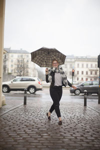 Rear view of woman standing on city street