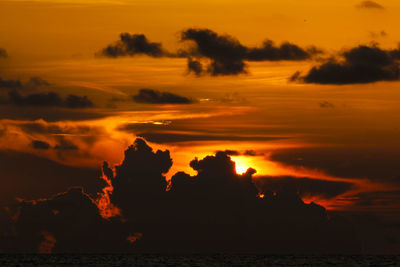 Scenic view of sea against romantic sky at sunset