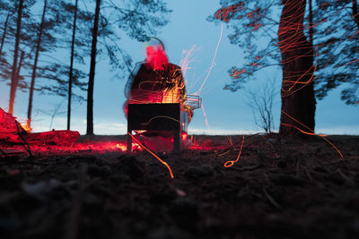 Surface level of fire on land against sky