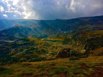 Scenic view of mountains against cloudy sky