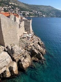 High angle view of buildings by sea