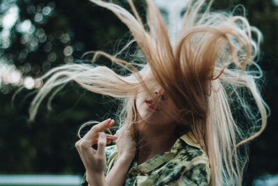 Young woman with tousled hair at outdoors