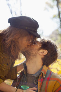 Happy young couple kissing in a park