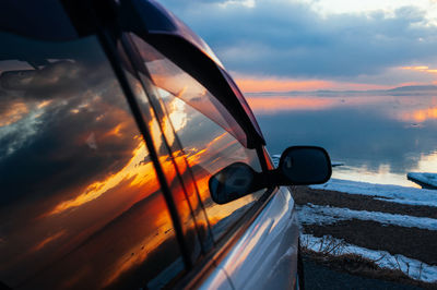 Car on road against sky during sunset