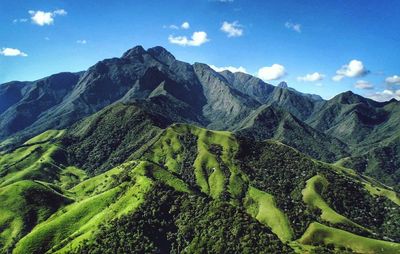 Scenic view of mountains against cloudy sky
